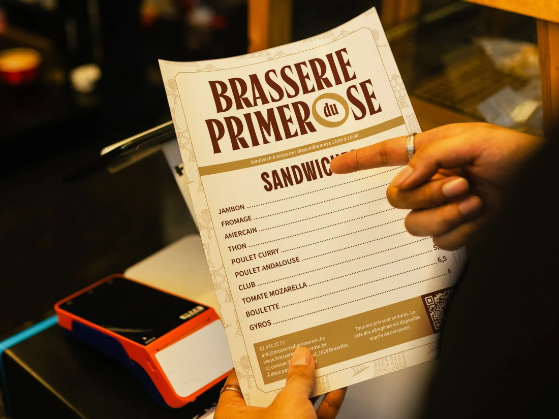 Brasserie du Primerose cream sandwich menu held at a restaurant counter.