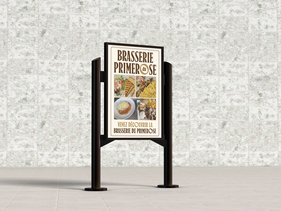 Primerose freestanding restaurant menu sign against a pale stone wall.