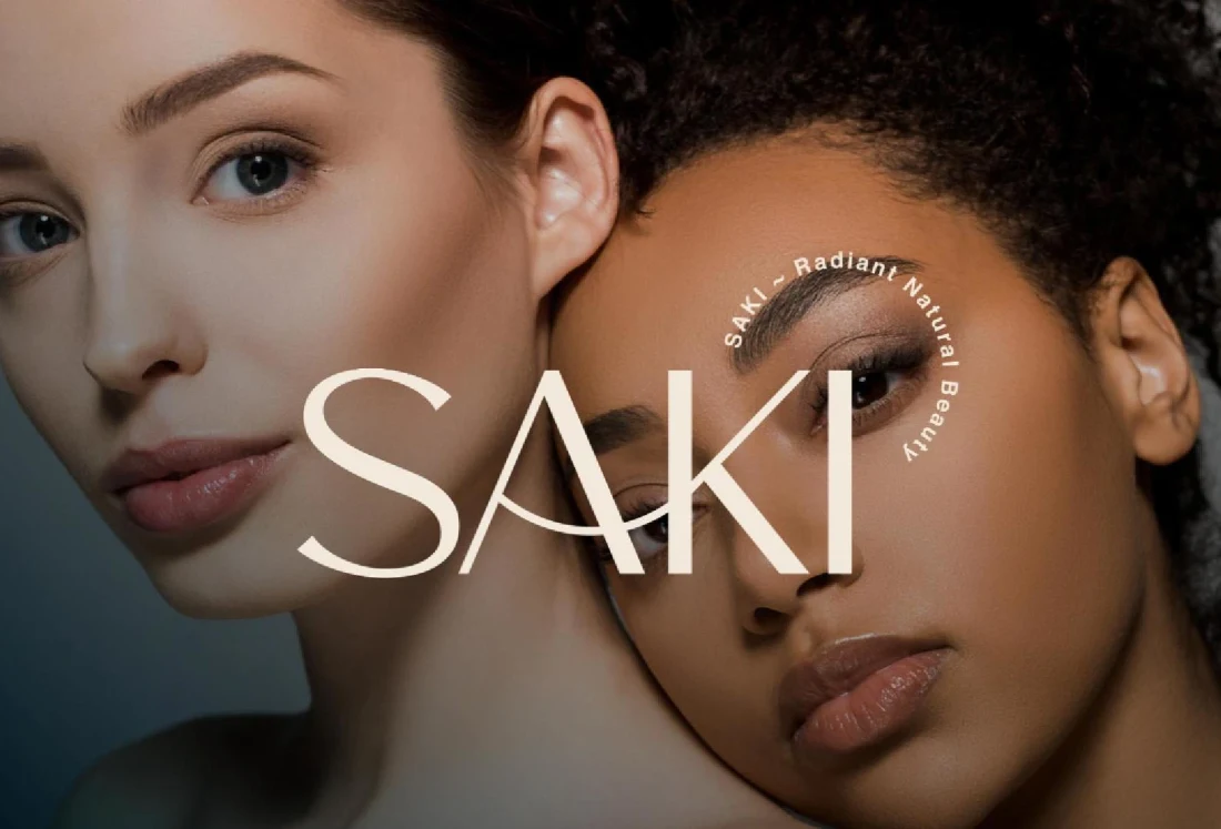 SAKI beauty campaign with two portraits and a spacious cream wordmark.